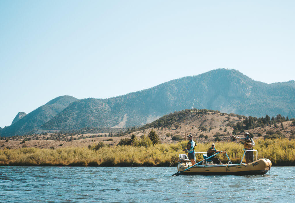 fly fishing guide and guests on a fly fishing float trip on the colorado river