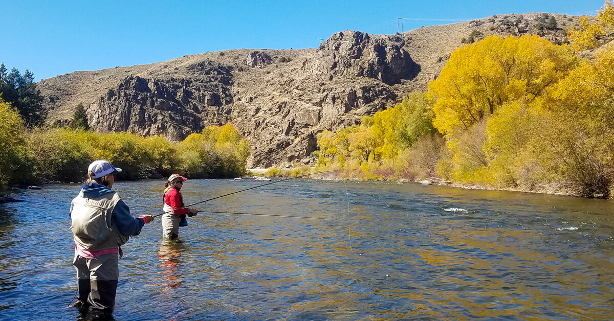 two women fly fishing the Arkansas River during the fall