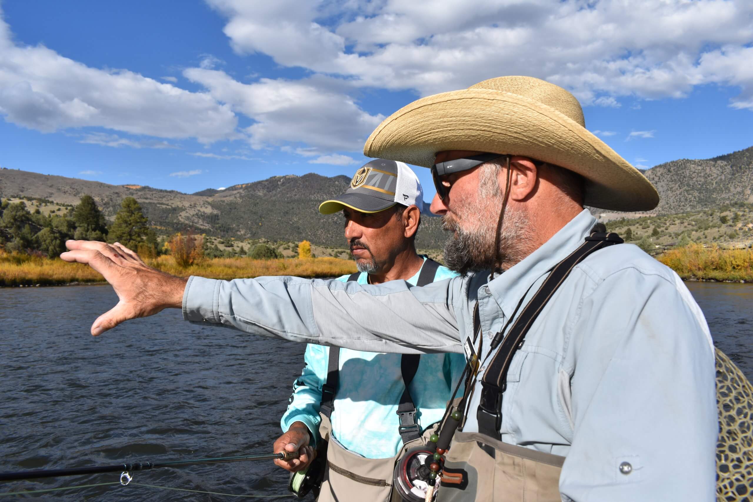 fly fishing guide wading with guest