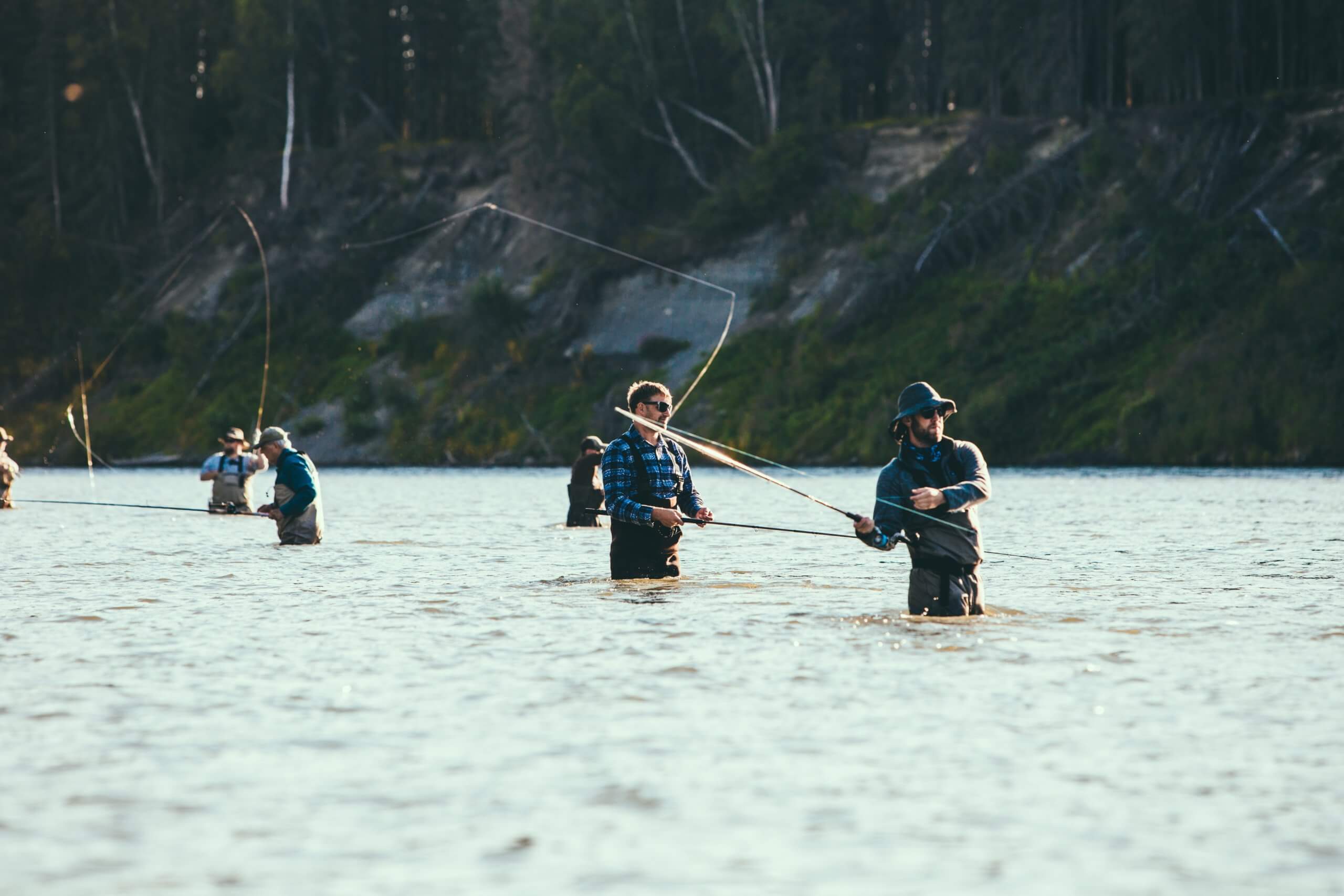 a group of men fly fishing