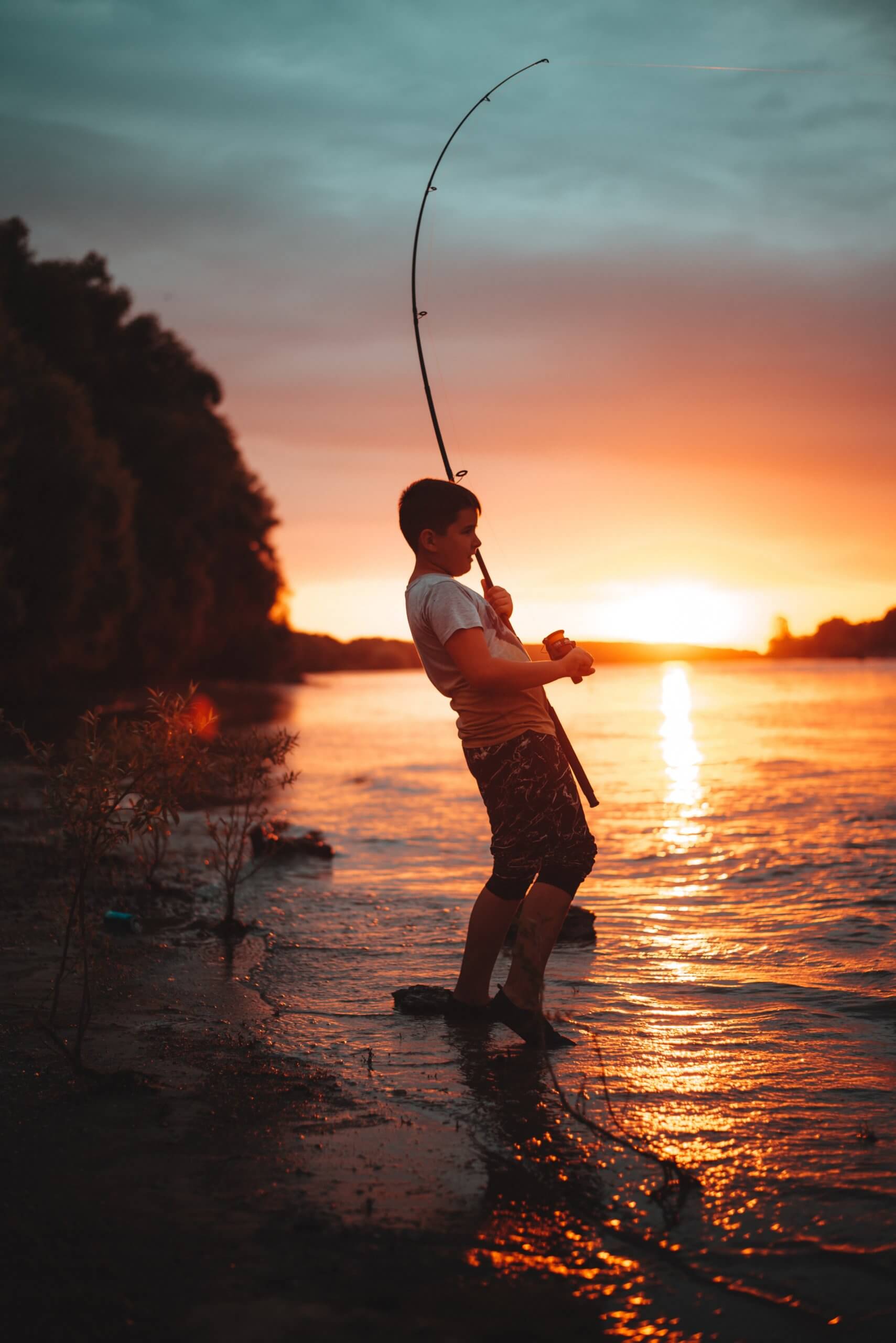 Kid fishing at sunset