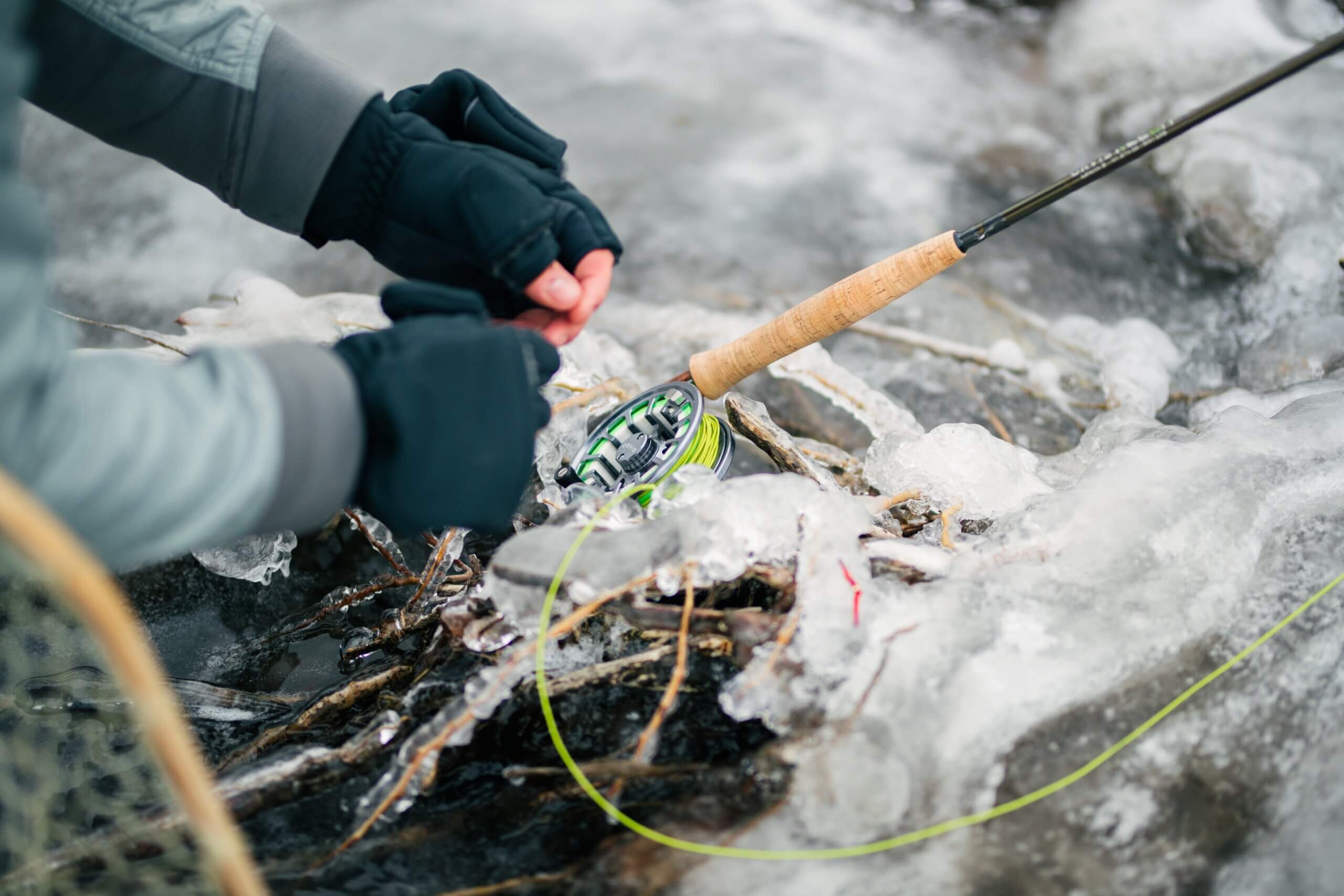 rod and line in icy river water