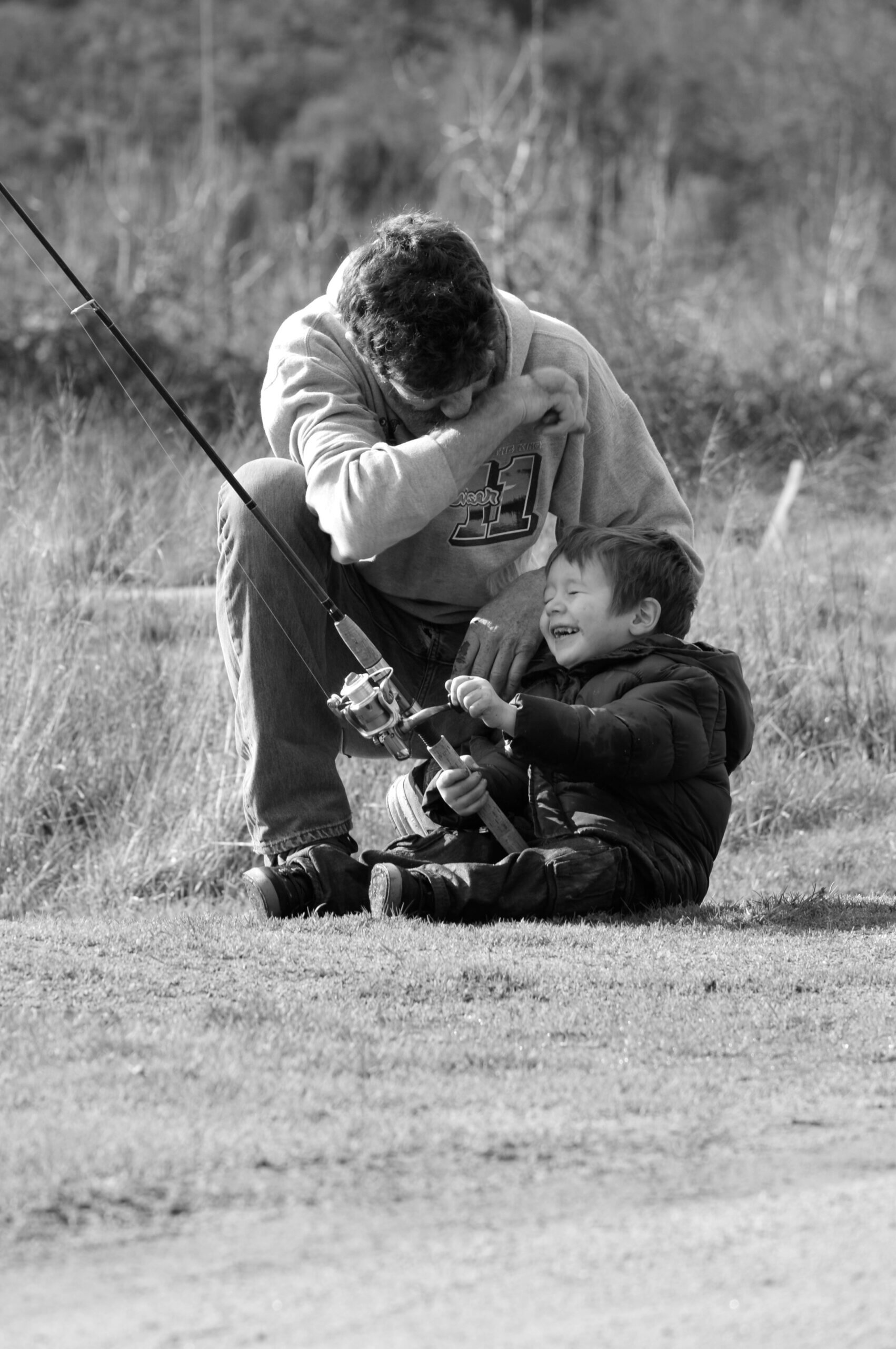dad and son holding fishing pole